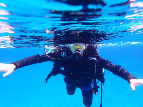 woman scuba diving in Greece near the surface, clear waters, blog feature
